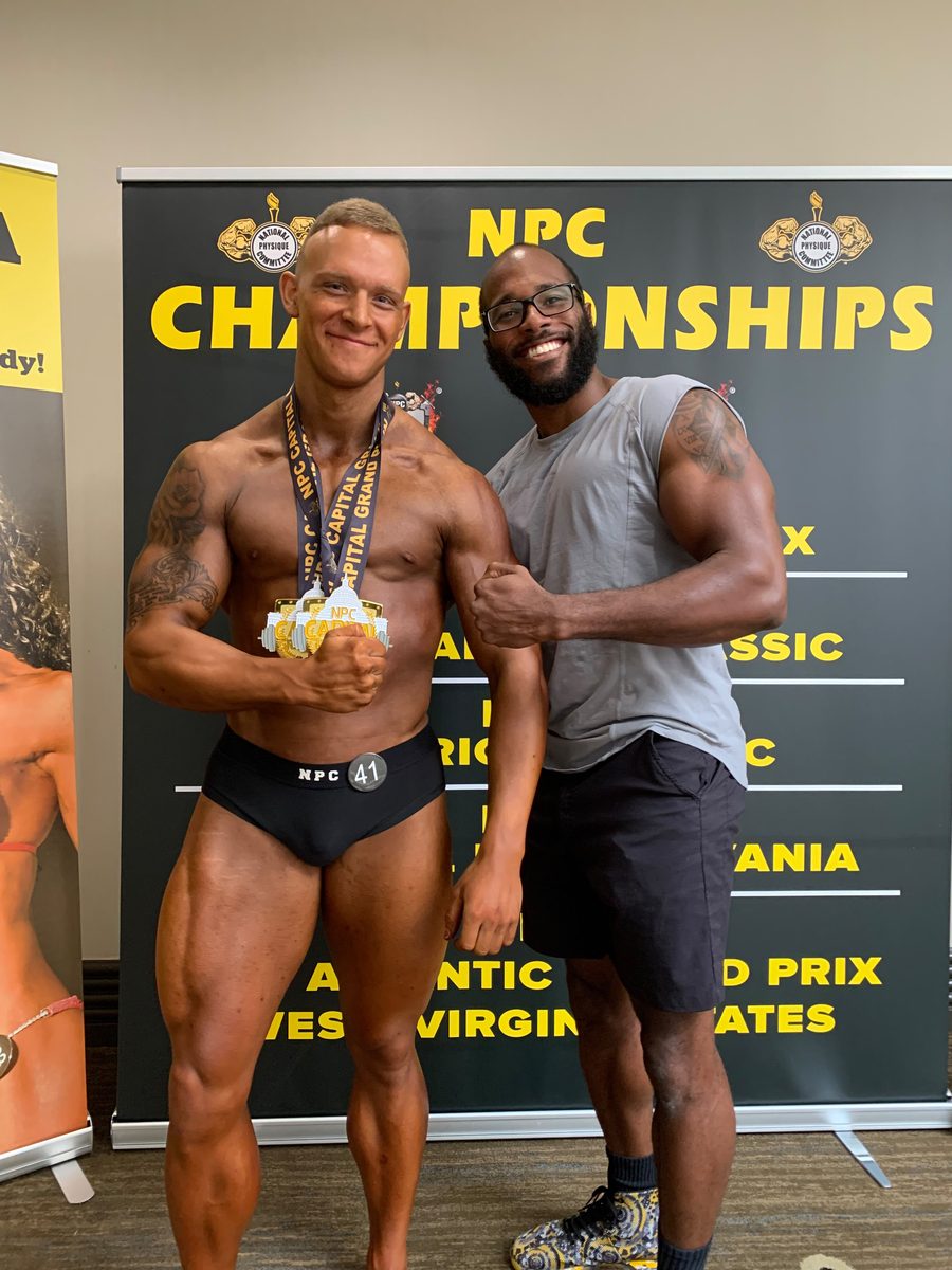 Client with his medals at the NPC Championships alongside Coach Tae
